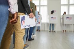 voters lining up with their ballots at a voting station