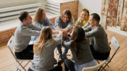 People holding hands at a cocaine anonymous meeting