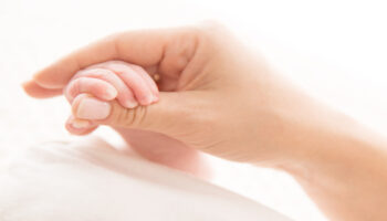Newborn Baby Hand Holding Mother