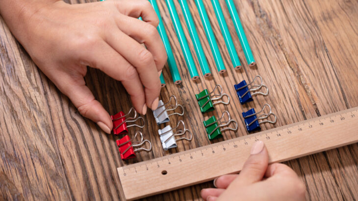 Pencils and paper clips meticulously organized, signifying symptoms of obsessive-compulsive disorder (OCD)