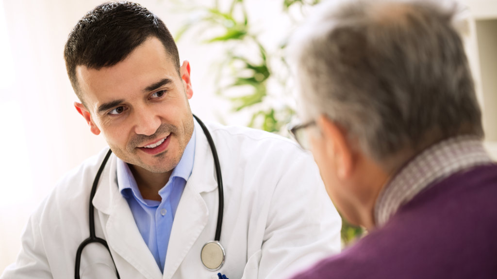 a doctor speaks with a patient about mental health grants for addiction therapy