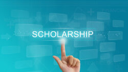 A person points towards a graphic that says "scholarship'. Mental health grants can make access to rehab and addiction therapy more affordable.